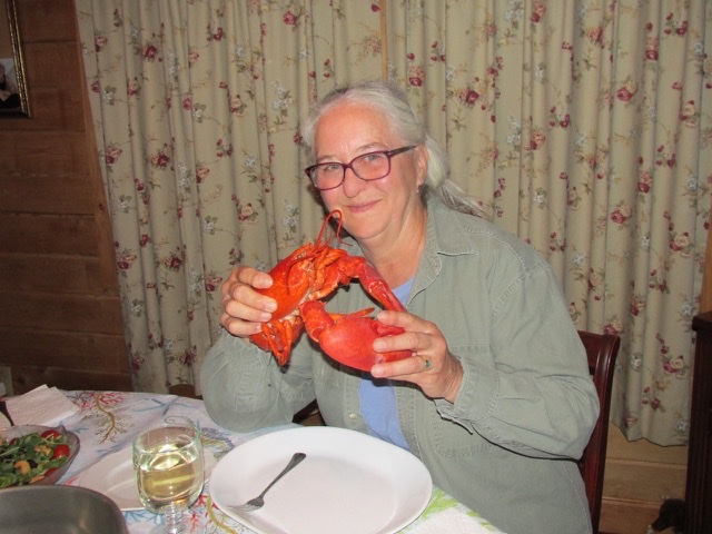 Waive, smiling at a dinner table.